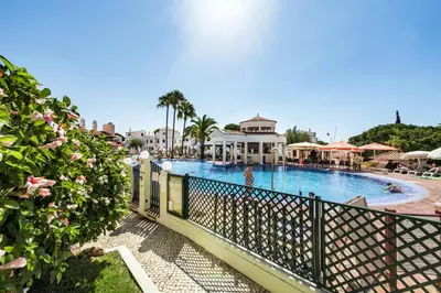 a view of a swimming pool in a resort at Spacious 3BR Apartment in Vilamoura Old Village with Rooftop BBQ, Pools & Panoramic Views in Quarteira