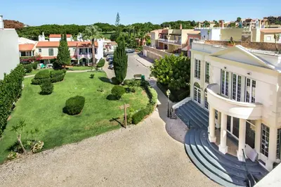 an aerial view of a house with a yard at Spacious 3BR Apartment in Vilamoura Old Village with Rooftop BBQ, Pools & Panoramic Views in Quarteira
