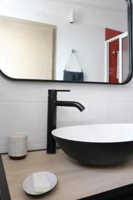 a bathroom with a sink and a mirror at Birdy House in Faro